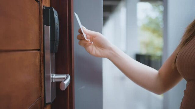 Closeup female's hand opening the room by key card access the hotel room. 4K slow-motion footage