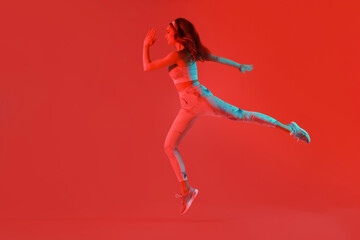 Fototapeta na wymiar Sporty running woman on color background
