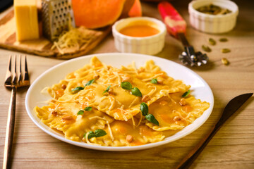 Homemade Pumpkin Ravioli with ricotta cheese served basil