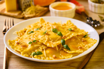 Homemade Pumpkin Ravioli with ricotta cheese served basil