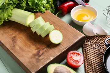 Different fresh ingredients on color wooden background