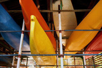 Set of water kayaks on shelves in storage
