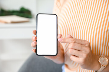 Woman pointing on blank mobile phone screen, closeup