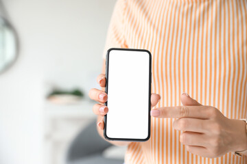 Woman pointing with finger on blank mobile phone screen, closeup