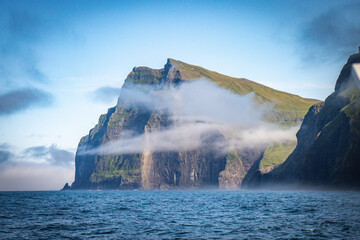Fototapeta na wymiar cliffs with morning fog, vestmanna, streymoy, faroe islands, north atlantic, europe