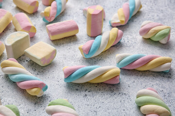 Fototapeta na wymiar Different sweet marshmallows on light background, closeup