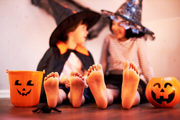 heels of children, and in the background girl and boy in costumes for Halloween