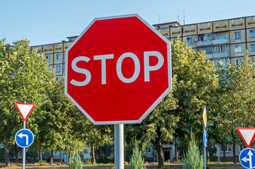 Road sign "stop" instructing drivers to stop completely