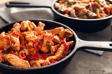 Frying pan with tasty chicken Fajita on grey background, closeup