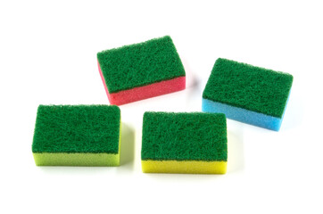 Colored sponges for washing dishes and other domestic needs. Yellow, green, blue and red abrasive sponge.