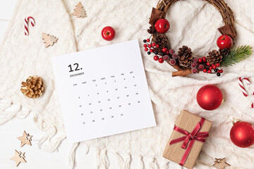 Christmas background with calendar for December and xmas decoration. Winter holidays celebration concept. Flat lay, top view