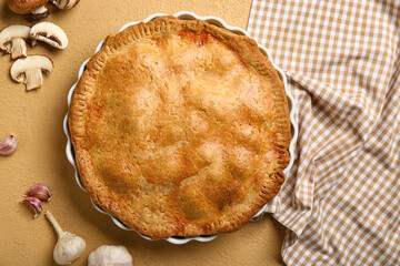 Baking dish with tasty chicken pot pie on beige background