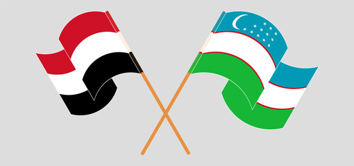 Crossed and waving flags of Yemen and Uzbekistan