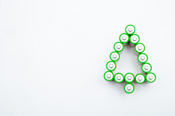 The batteries are in the shape of a Christmas tree on a white background. top view, flat lay, copy space, isolate. High quality photo