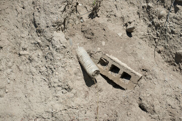 plastic drain pipe and cement block - landfill 