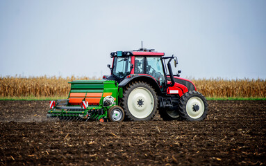 Sowing time. Farmer working in the field with a tractor. Agricultural concept