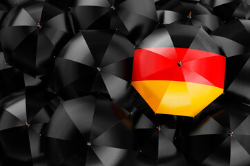 Umbrella with German flag among black umbrellas, 3D rendering