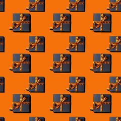 seamless pattern gift boxes tied with ribbon with Halloween decor on orange background