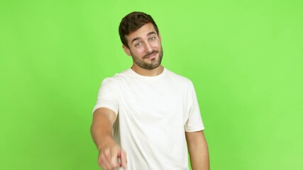 Handsome man points finger at you with a confident expression over isolated background