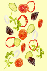 Light spring summer salad with flying floating in air ingredients, fresh vitamin vegetables. Suspended onion, tomato, cucumber, pepper, parsley, basil. Vegetarian vegan healthy food menu