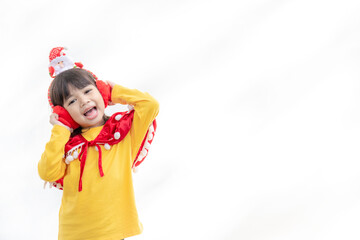 Asian little girl in red santa hat on white background.