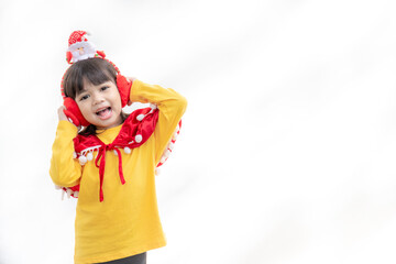 Asian little girl in red santa hat on white background.