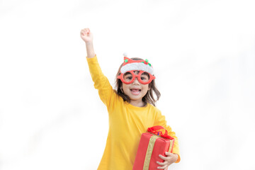 Happy adorable Asian child girl with Christmas gift in hands on white background