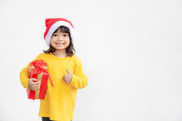 Happy adorable Asian child girl with Christmas gift in hands on white background