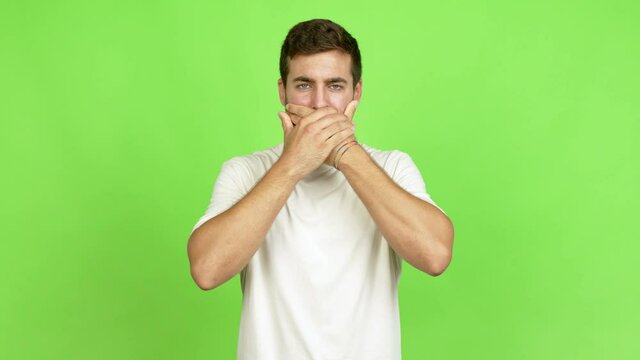 Handsome man covering mouth with hands. Can not speak over isolated background