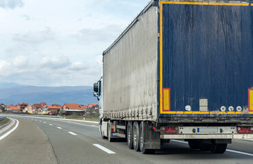 Truck on the road and cloudy sky.