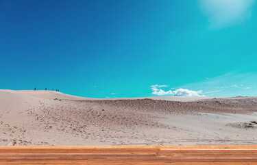 Landscape with dunes and wooden deck.