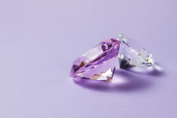 Purple precious gemstones for design gems jewellery. Big diamonds crystal on purple background.