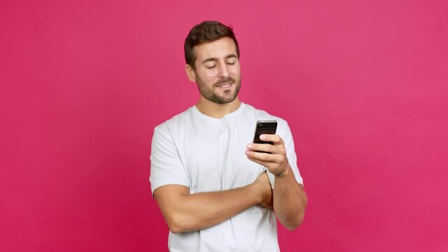Handsome man using mobile phone over isolated background