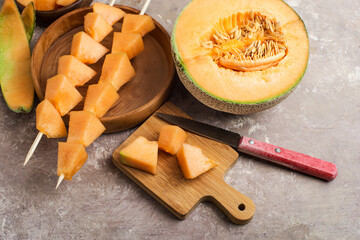 bowl of melon slices and slices on skewers.