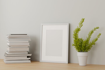 Blank white picture frame mock up on the table with a book in white living room design. 3d rendering.