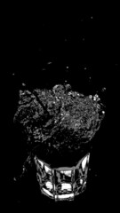Water Splashing a Glass on a Black Background