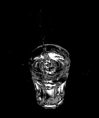 Water Splashing a Glass on a Black Background