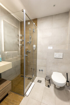 Interior of a hotel bathroom with a glass shower cabin