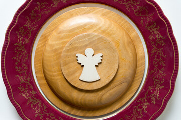 wooden plate with angel on an antique dish