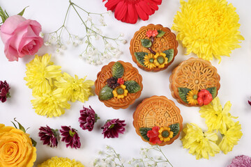 Colorful flower decorated moon cake Chinese mid autumn festival daisy chrysanthemum mum rose baby breath flower red yellow pink purple violet on white background