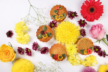 Colorful flower decorated moon cake Chinese mid autumn festival daisy chrysanthemum mum rose baby breath flower red yellow pink purple violet on white background