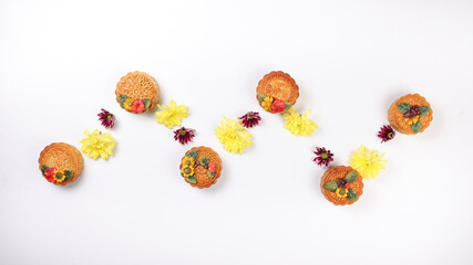 Colorful flower decorated moon cake Chinese mid autumn festival yellow violet chrysanthemum mum flower on white background