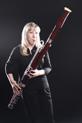 Bassoon woodwind instruments player. Classical musician - obrazy, fototapety, plakaty