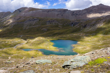 Hiking trail in Cogne valley, Aosta, Italy. Lake of Doreire in the high walloon of Grauson near the pass of Invergneux. Photo taken at 2800 meters of altitude.