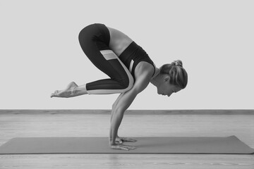 Young woman yoga teacher in studio