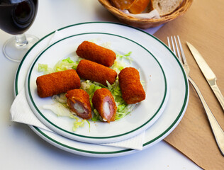 Spanish flamenquines, breaded pork loin rolled with serrano ham, typical of Andalusia