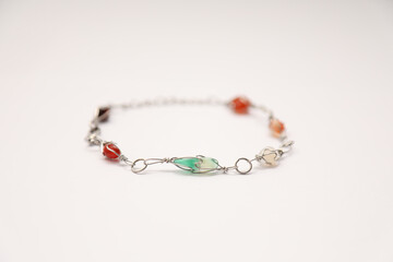 Closeup of a simple wire bracelet with gemstones isolated on a white background