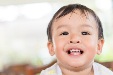 Happy asian boy child showing front teeth with smile and laughing : Healthy happy funny smile baby infant kid.Adorable toddler mixed race kid.portrait asian boy.dental healthcare.milk teeth.handsome.