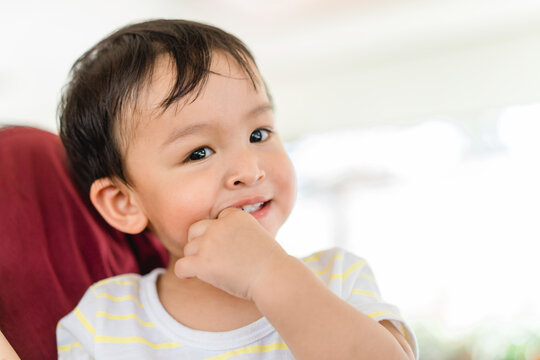 Baby Infant Kid Boy Putting Fingers On Mouth Touching First Milk Teeth Gums Pain Toothache.Bad Breath In Baby Kid.Adorable Mix Race Baby Male Toddler In Pain For New Baby Teeth.shy Kid Boy.dental.