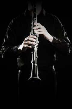 Clarinet player. Clarinetist hands playing woodwind music instrument close up